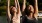 a couple of women raising their hands doing yoga